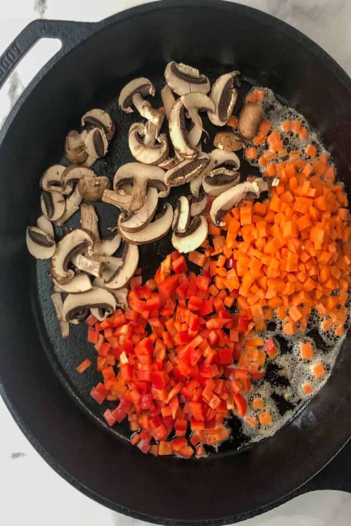 cooking mushrooms, carrots and peppers