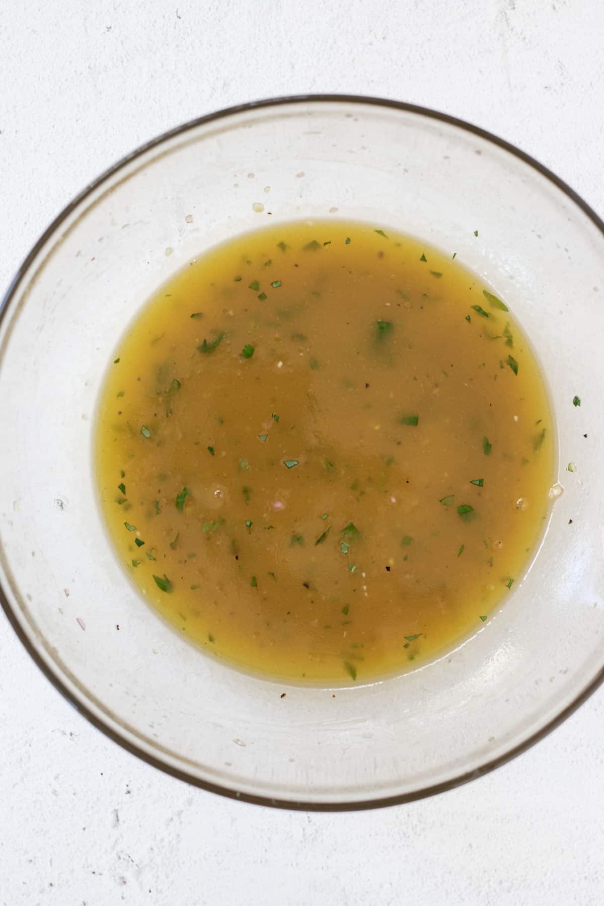 White balsamic dressing in a large glass bowl.