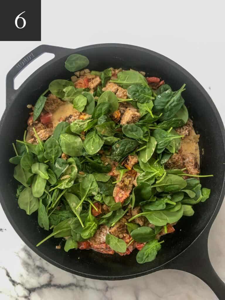adding spinach to pan