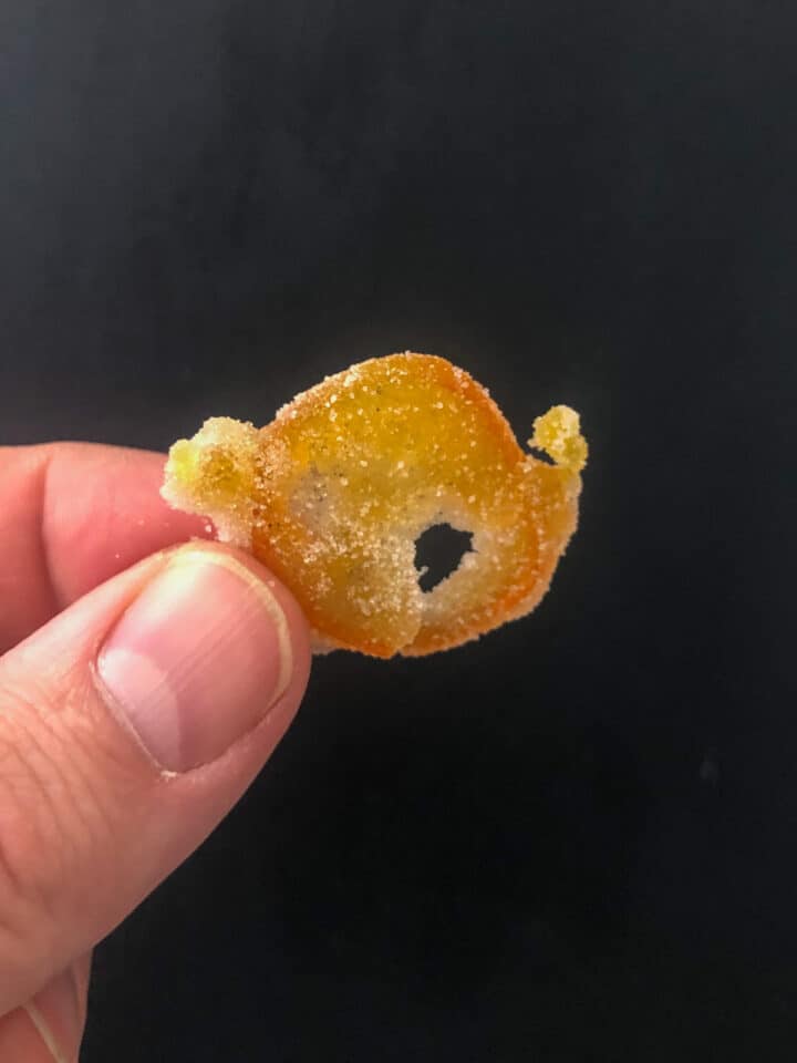 holding a candied kumquat slice