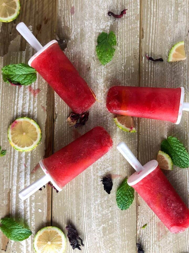 homemade lemonade hibiscus popsicles with mint, lemons, and dried hibiscus