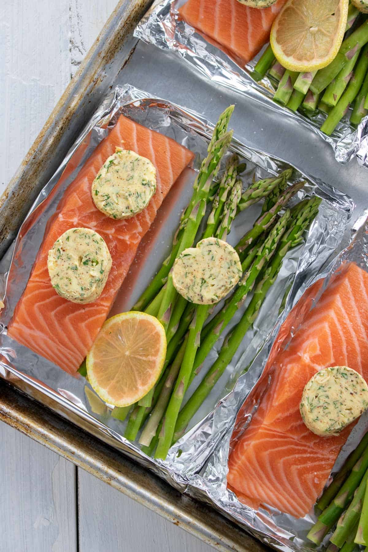 Salmon and asparagus inside foil boat.