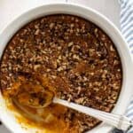 sweet potato souffle with pecans and a large spoon