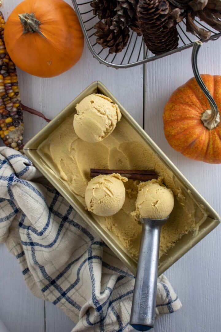 overhead shot of homemade creamy pumpkin ice cream with an ice cream scoop