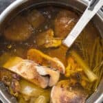 instant pot beef bone broth with a large spoon