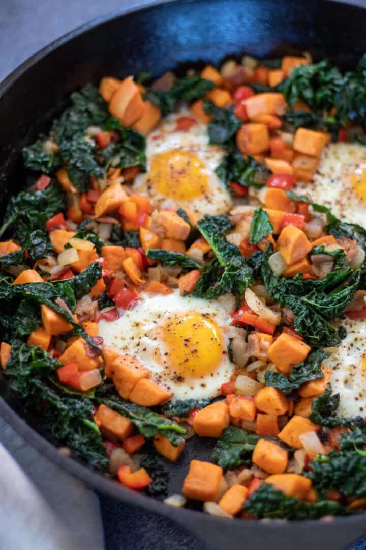 sweet potato hash with bacon and kale with sunny side eggs