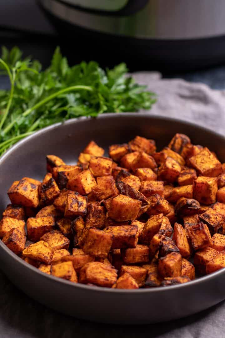 Straight on picture of sweet potato cubes with parsley.
