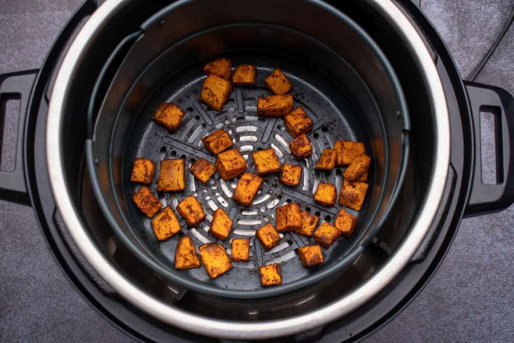 Crispy sweet potato cubes in air fryer.