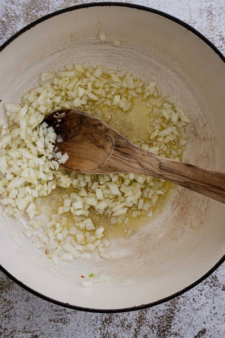 Cooking diced onions in a dutch oven.