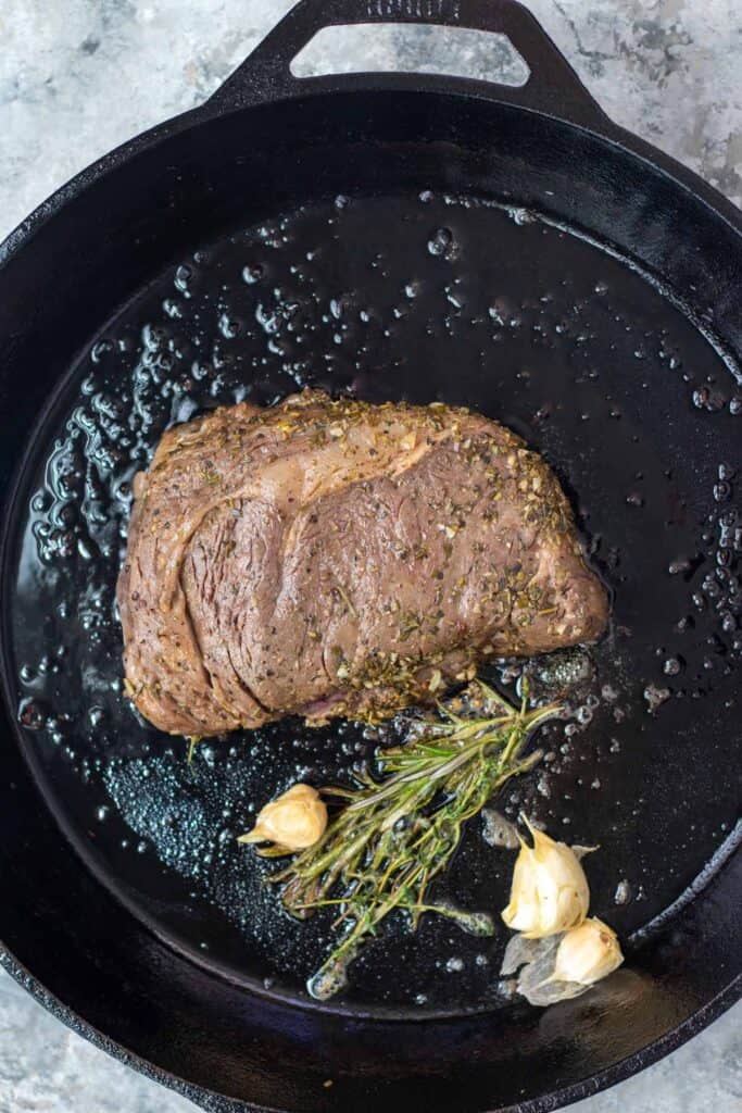 Searing a sous vide steak in a pan.