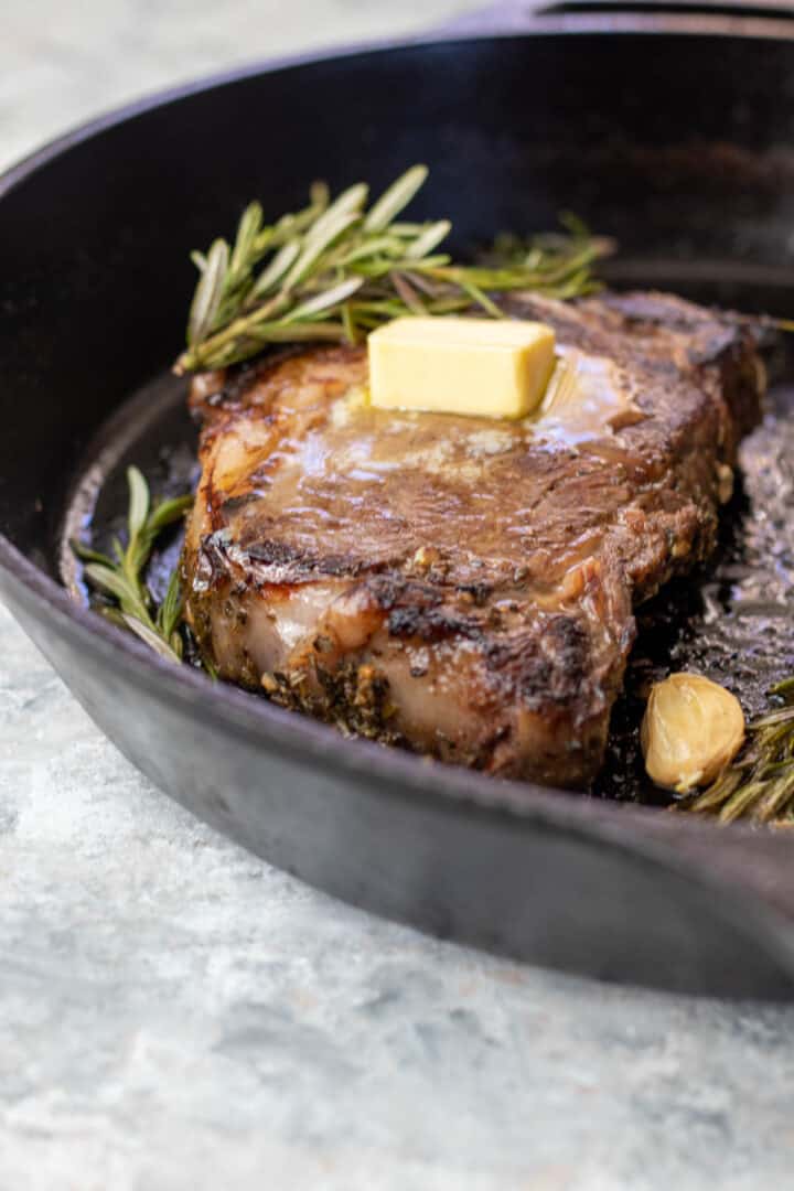 Seared steak in a cast iron pan.