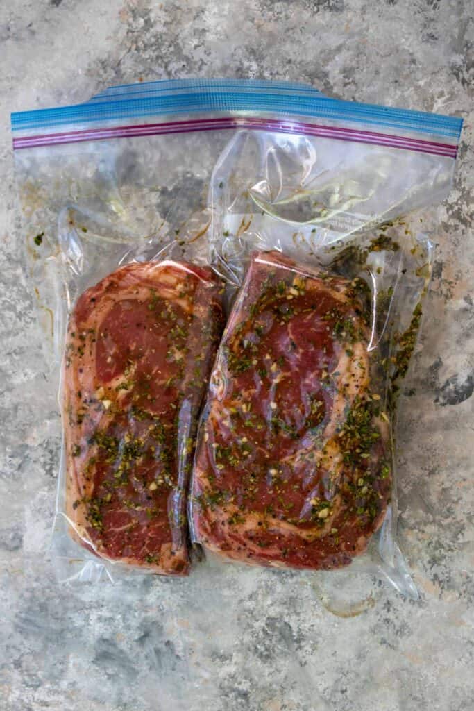 Marinated steaks in a ziplock bag.