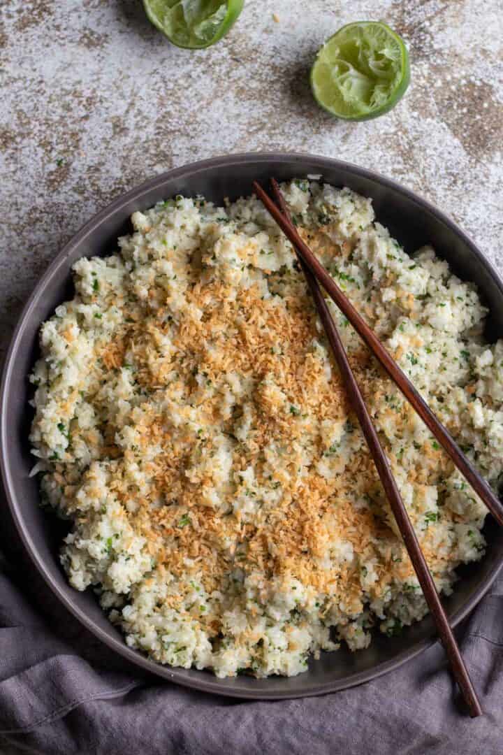 Cauliflower rice in a bowl with chopsticks.