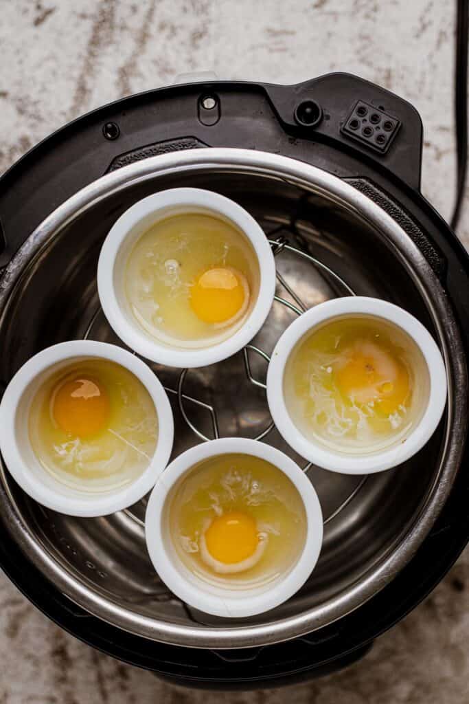 Eggs inside white ramekin cups.