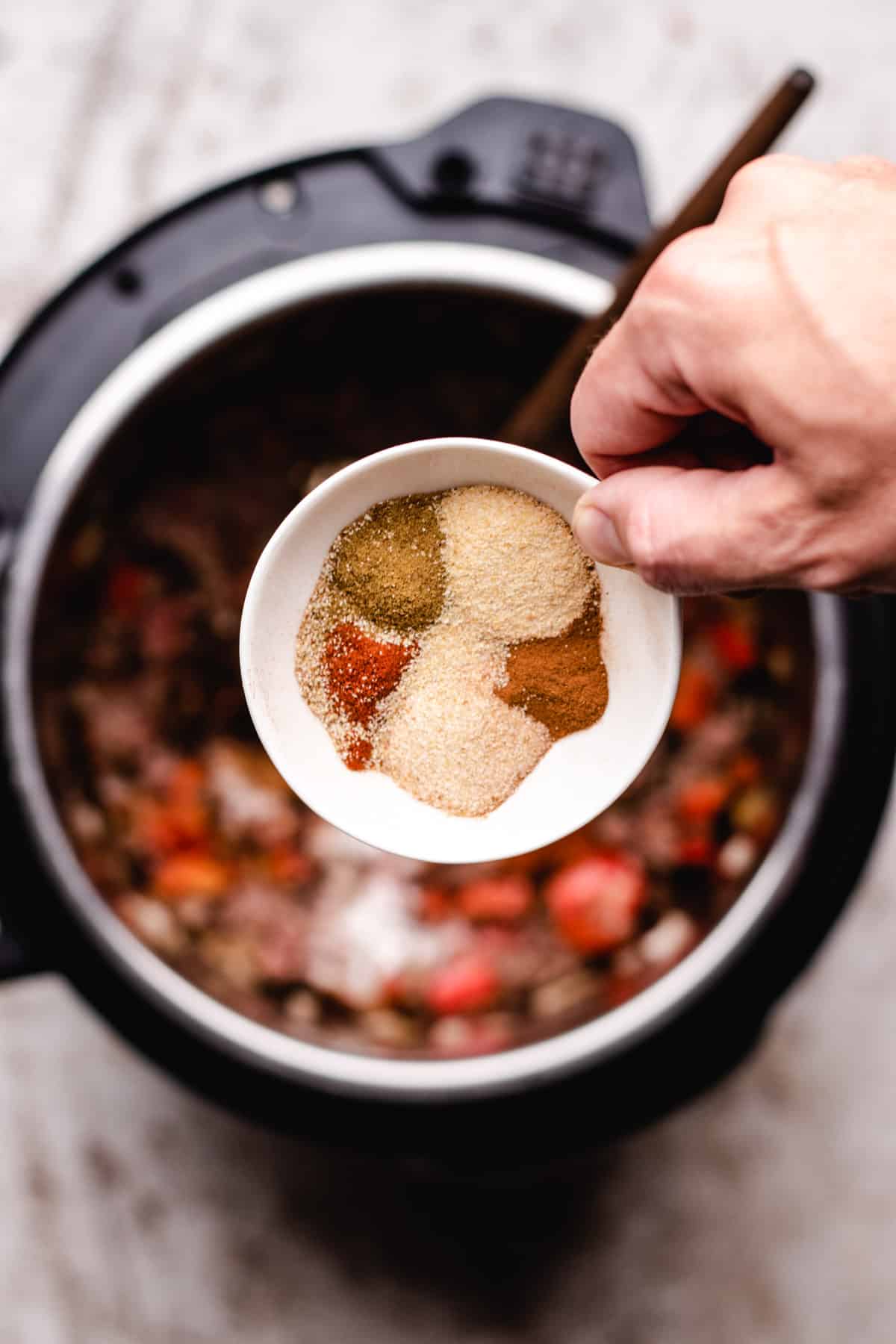 Adding spices to instant pot.