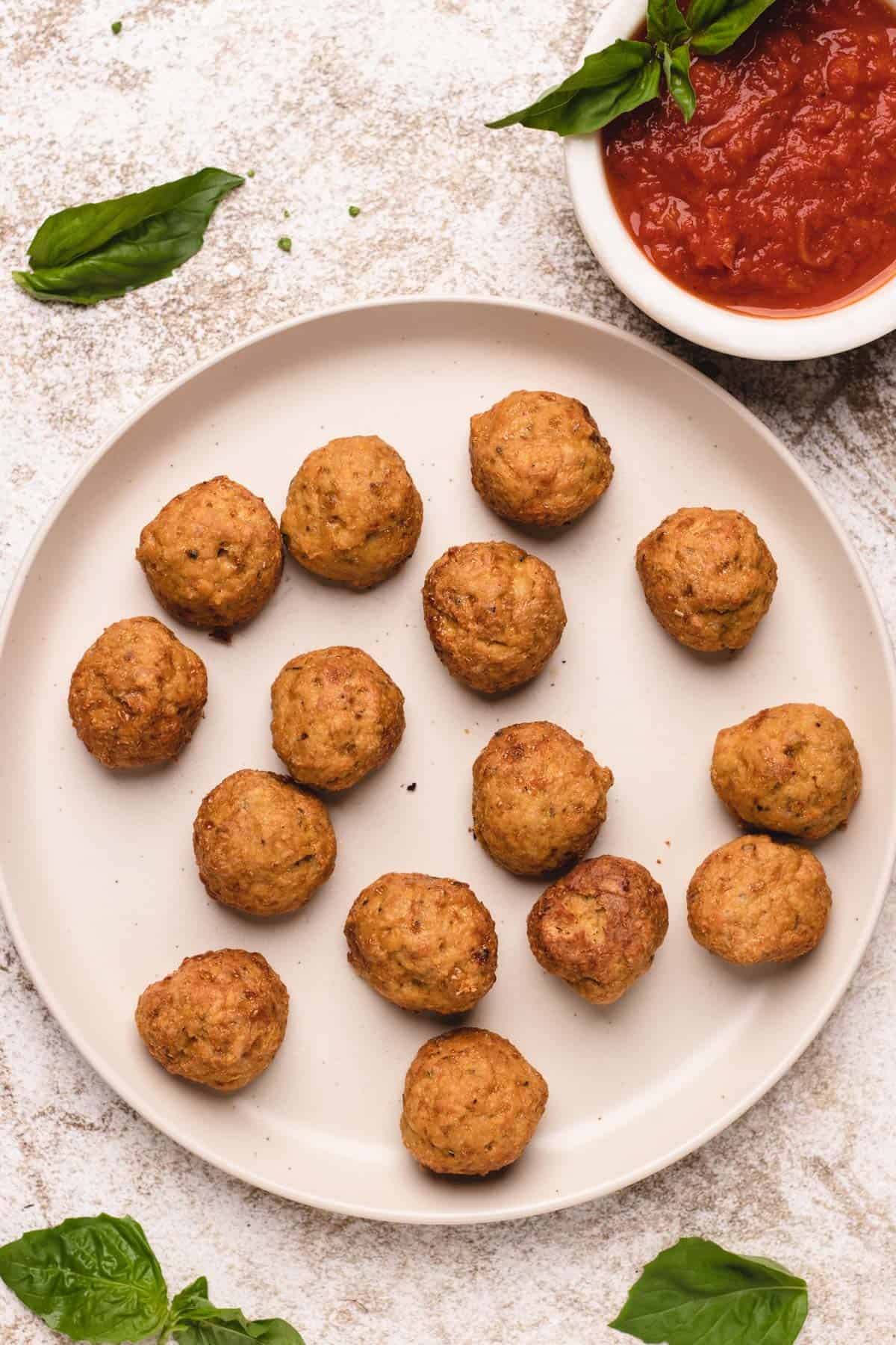 Chicken meatballs on a large plate.