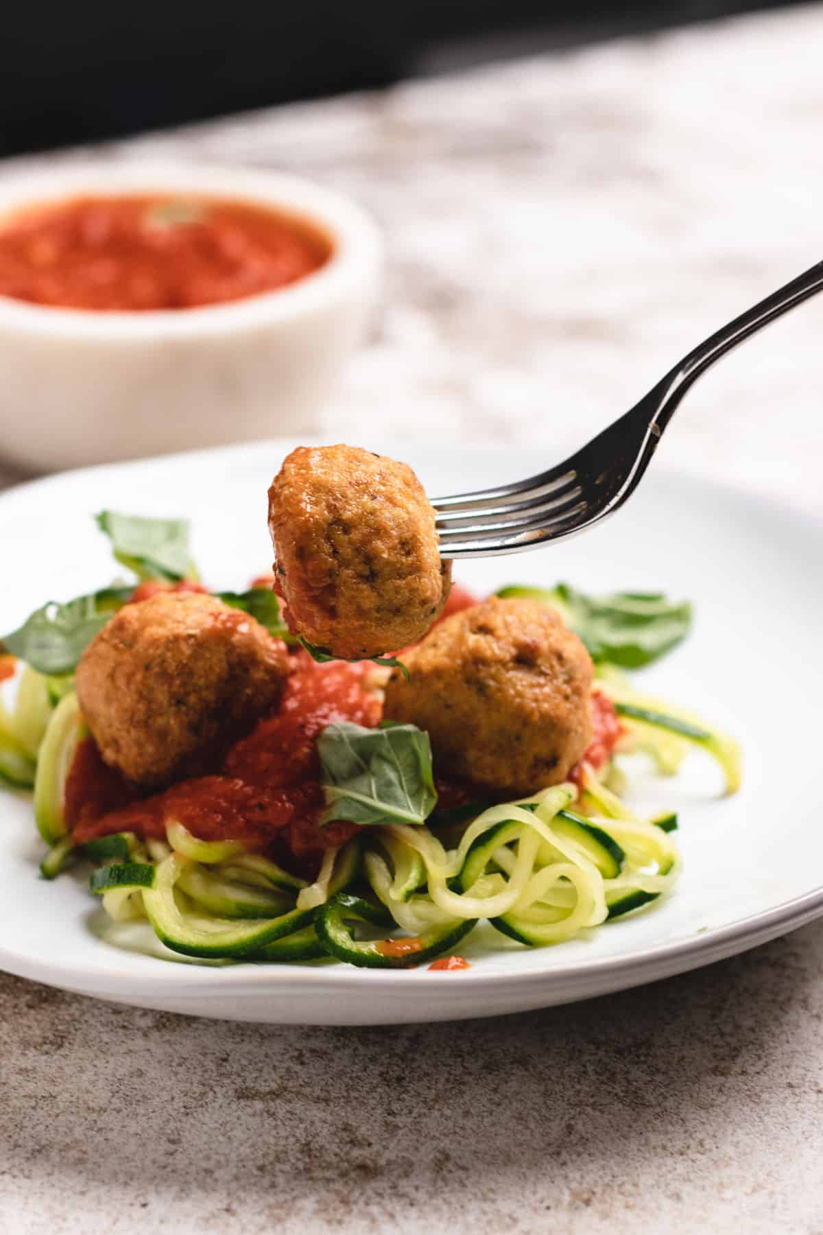 Chicken meatballs on top of zoodles.