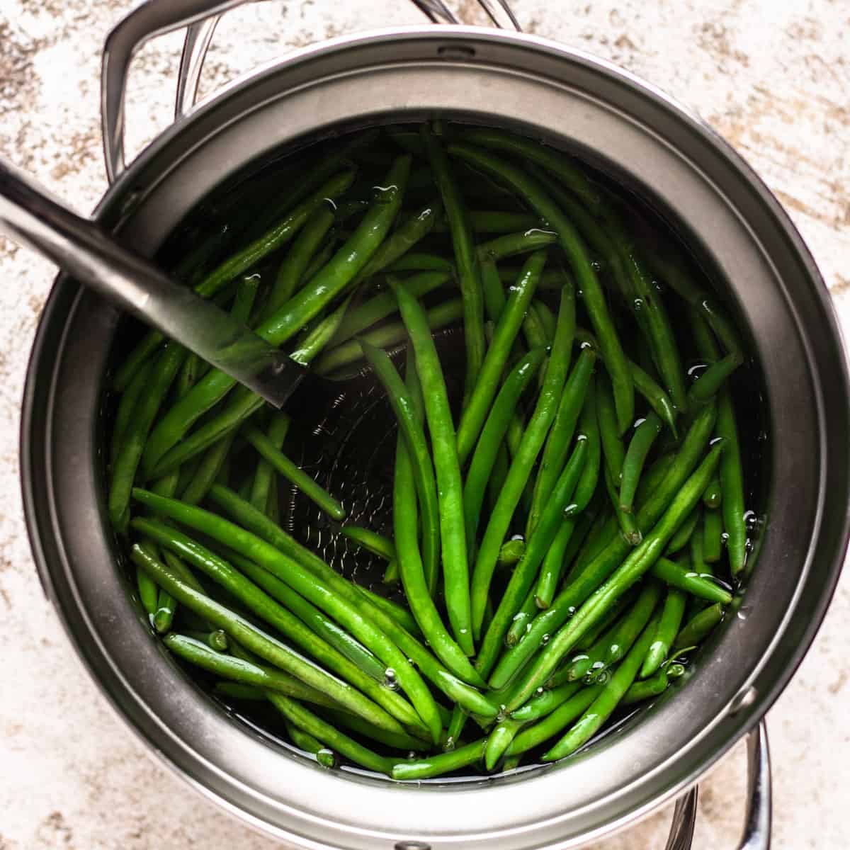 Cooking green beans in a large pot.