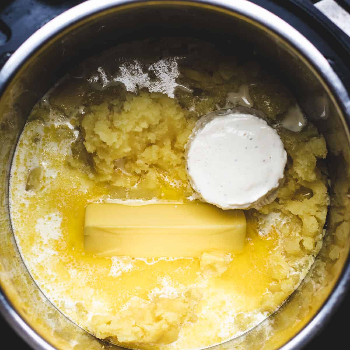 Mixing Boursin cheese into the mashed potatoes.