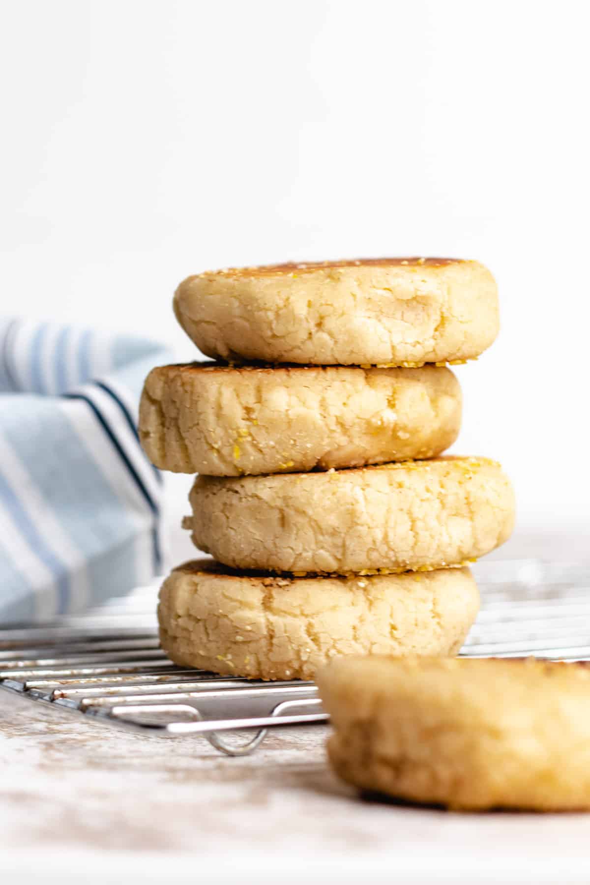 English muffins stacked on top of each other and slightly uneven.