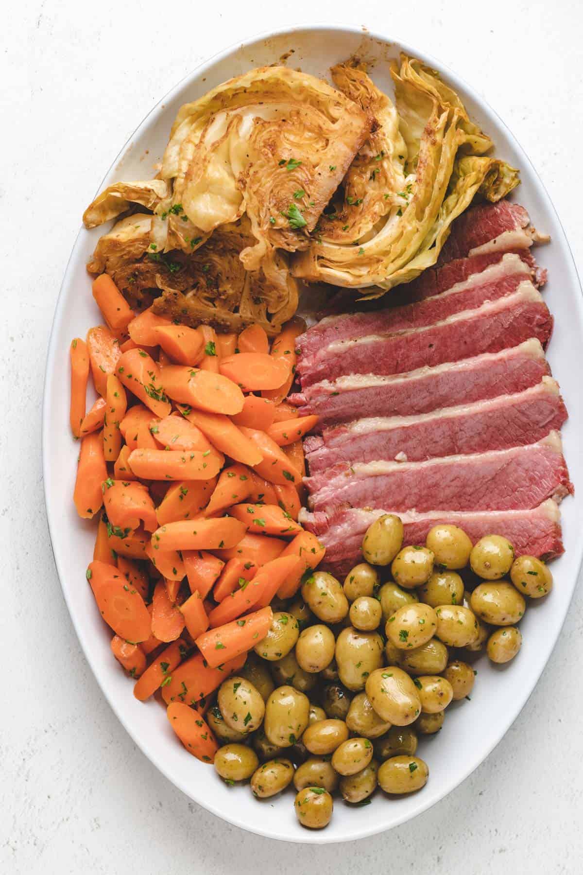 Sous vide corned beef, potatoes, carrots, and cabbage on a serving platter.