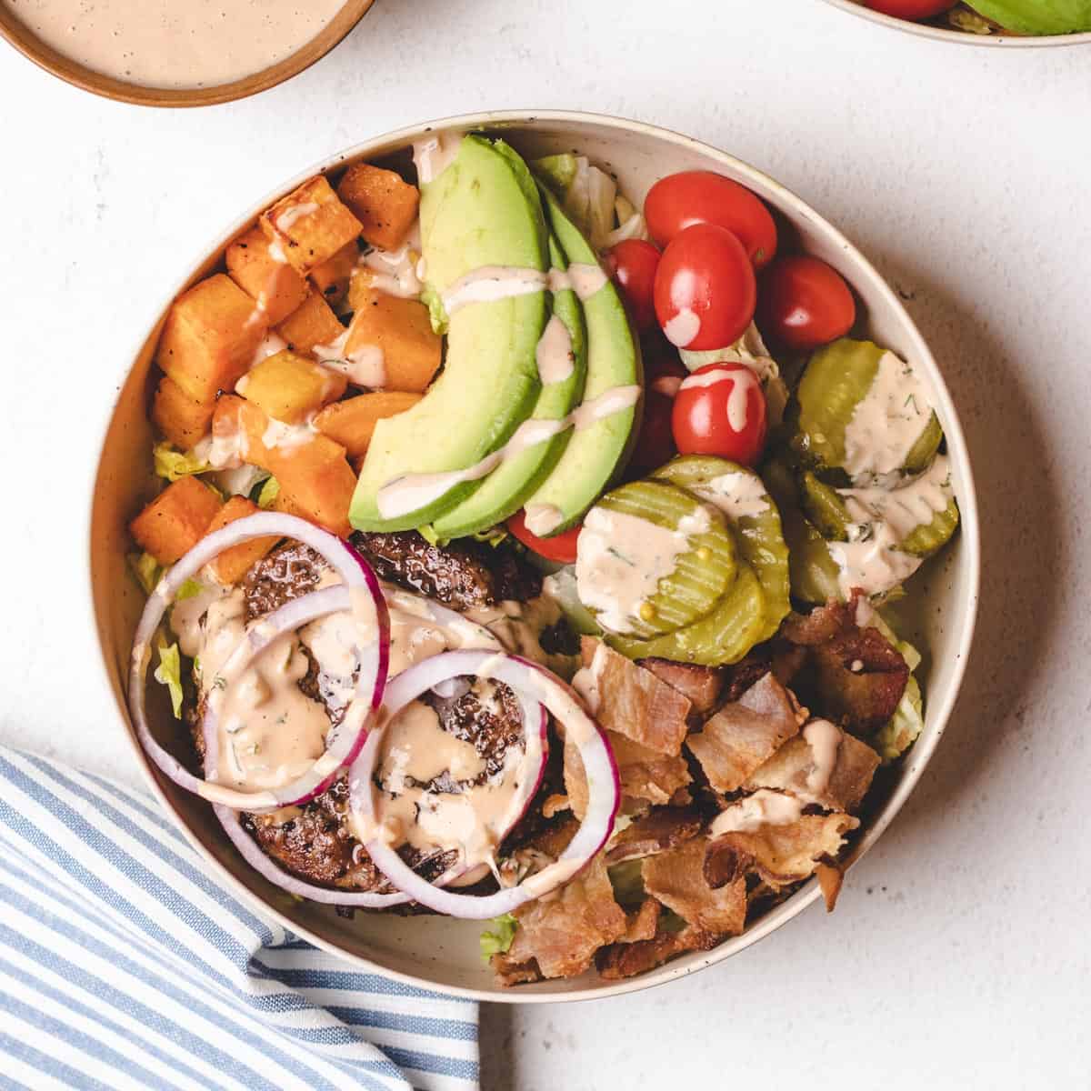 Overhead photo of a deconstructed burger in a bowl.