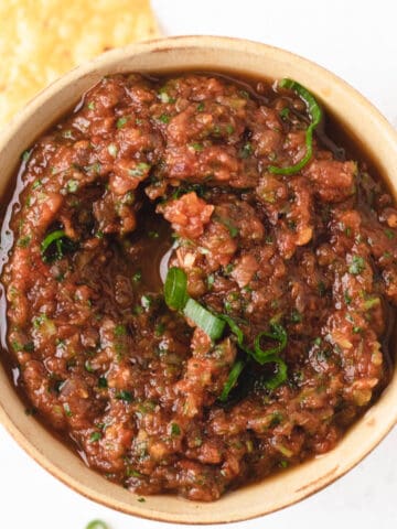 Close up photo of roasted red salsa in a small bowl.