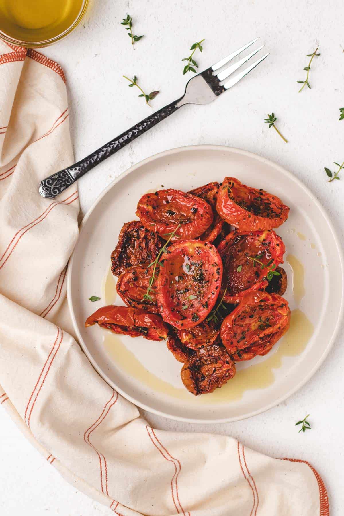 Overhead photo of air fryer roasted tomatoes on a small plate.