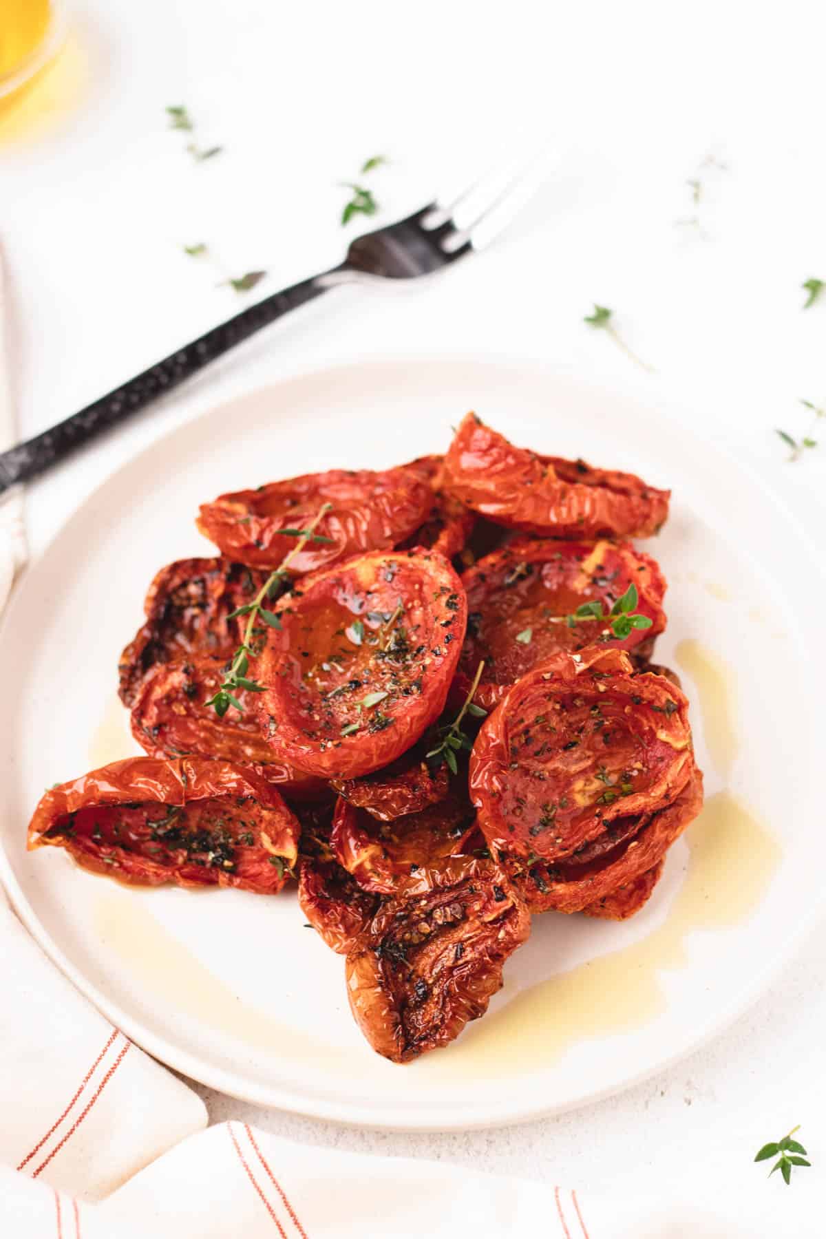 Slow roasted tomatoes piled high on a small plate.