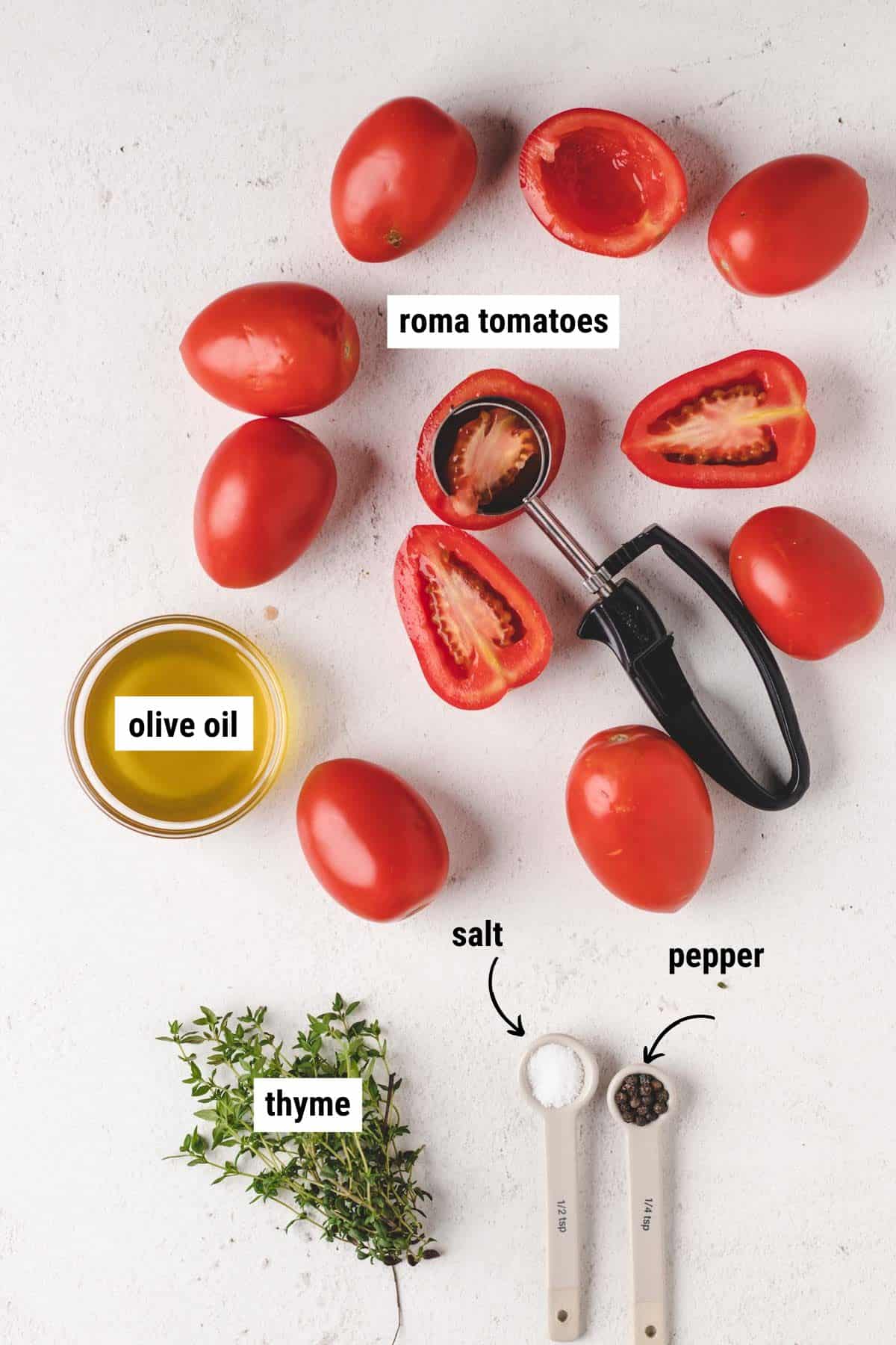 Overhead photo of Roma tomatoes, olive oil, fresh thyme, salt, and pepper.