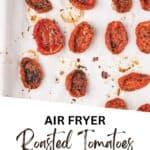 Photo of roasted tomatoes on a parchment-lined baking tray.
