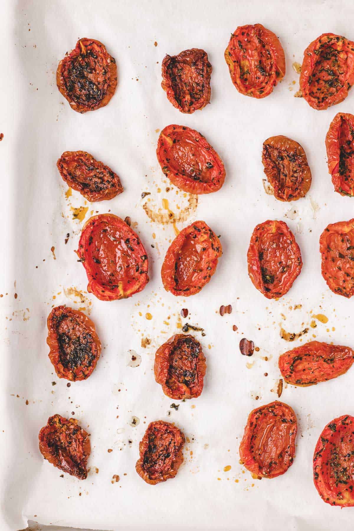 Slow roasted tomatoes that have been cooked and are now on a baking tray.