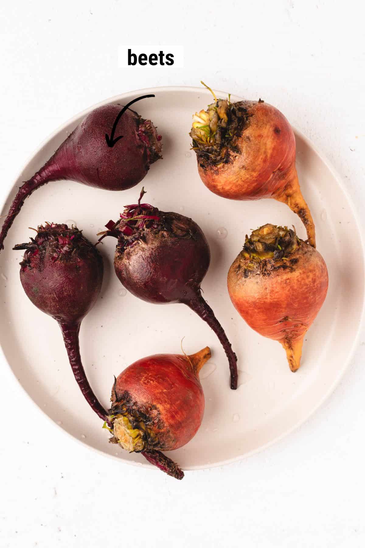 Red and golden beets on a large round plate.