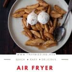 Air fryer apples with two scoops of vanilla ice cream on top.