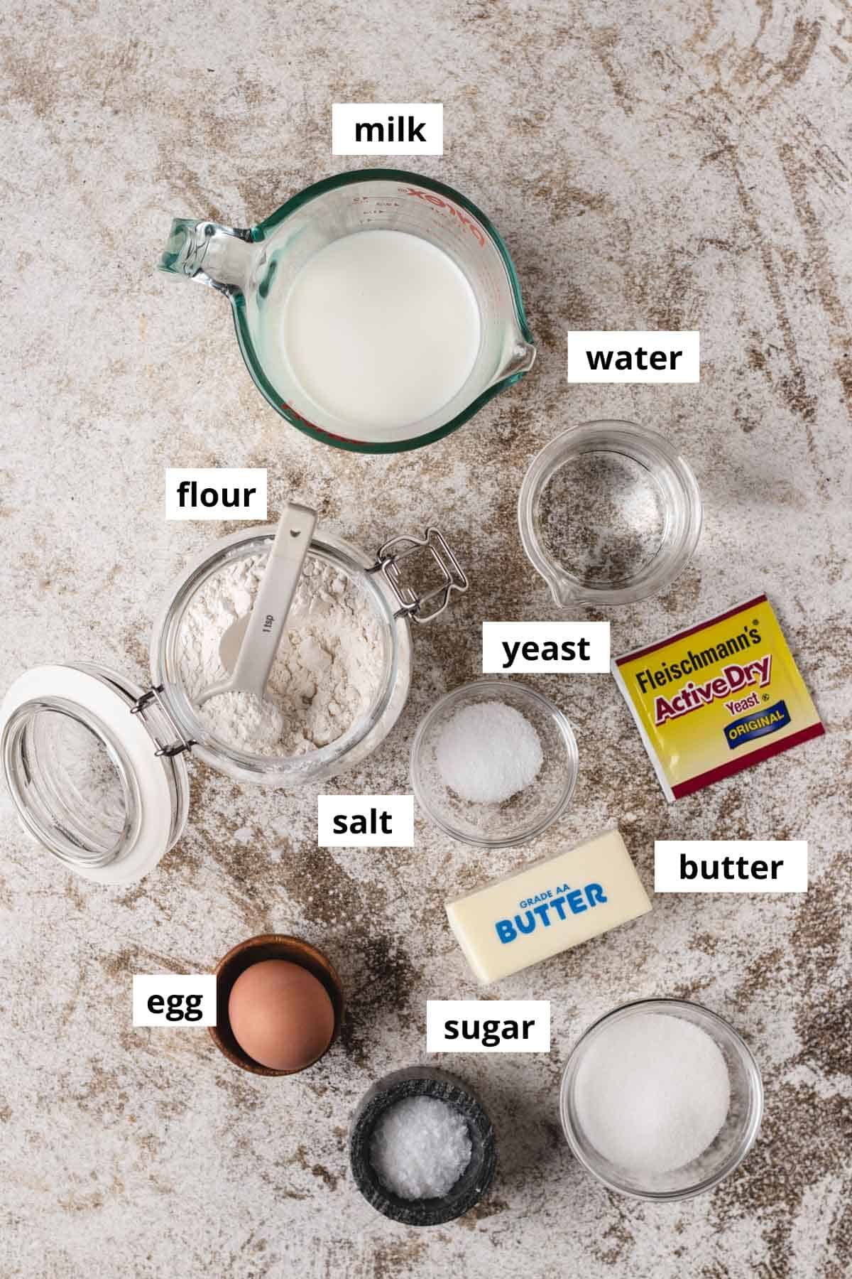 Milk, flour, water, yeast, salt, butter, eggs, and sugar.