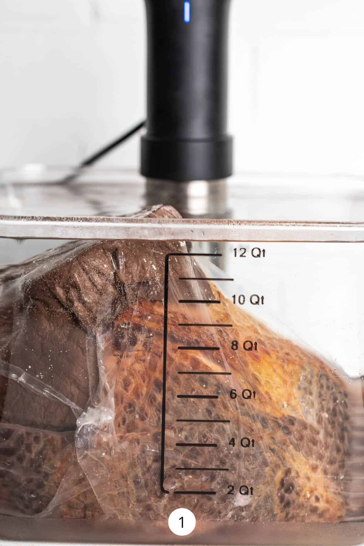 Vacuum sealed sous-vide ham inside a water bath.