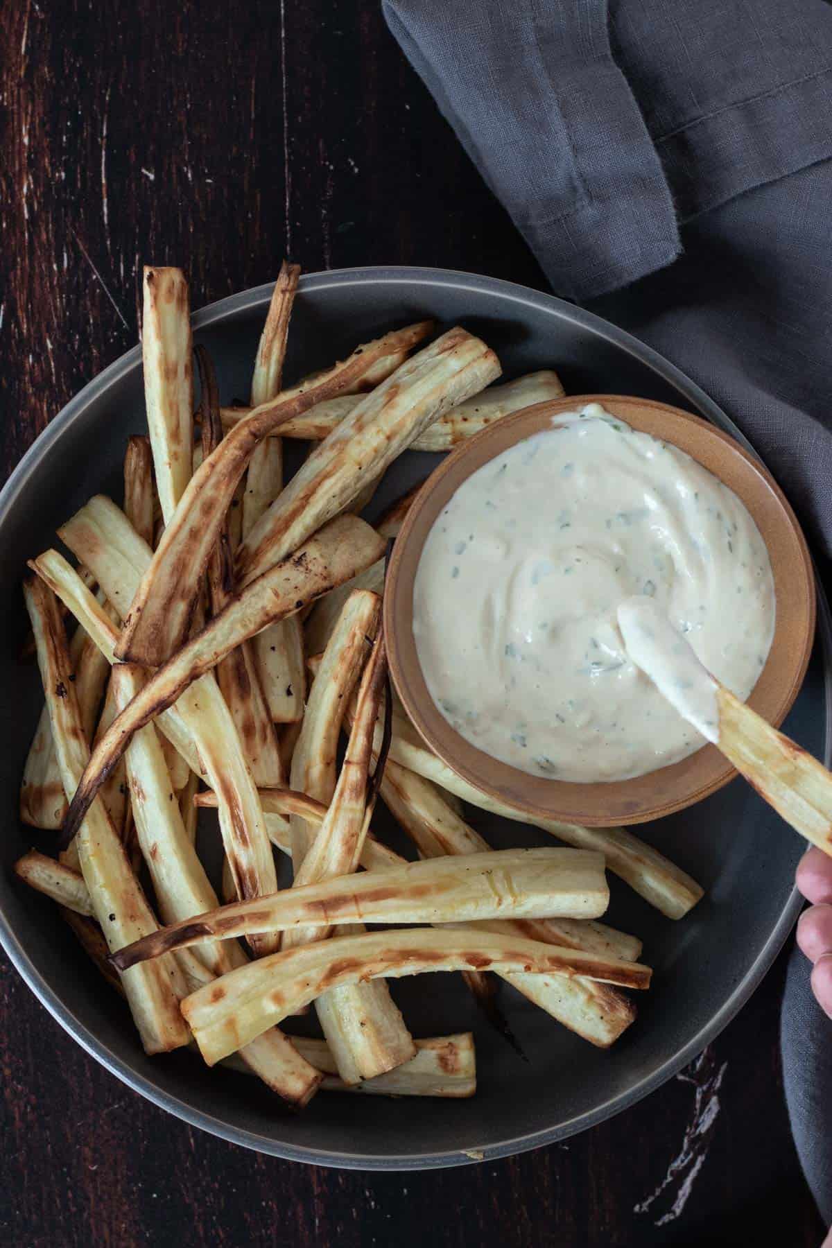 Dipping one parsnip fry into the tarragon aioli sauce.