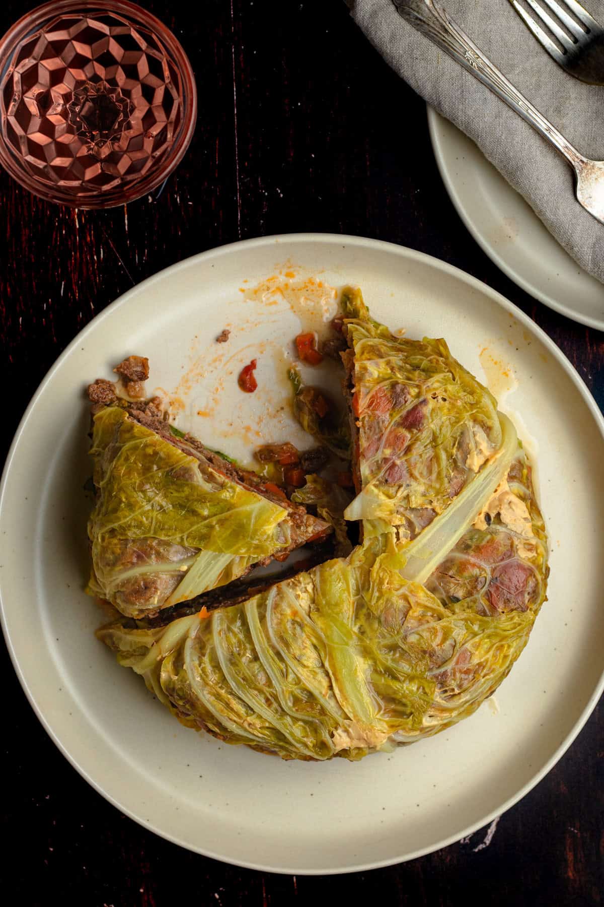 Chou Farci with one slice removed, on a large dinner plate.