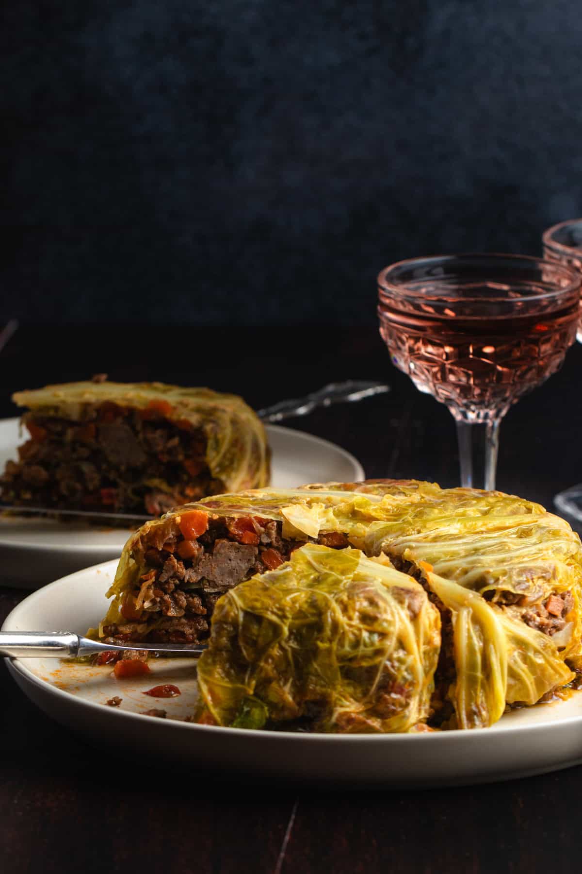 Chou Farci on a large dinner plates with a glass of Rose wine.