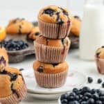Three blueberry and cottage cheese muffins stacked on top of each other.