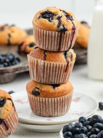 Three blueberry and cottage cheese muffins stacked on top of each other.