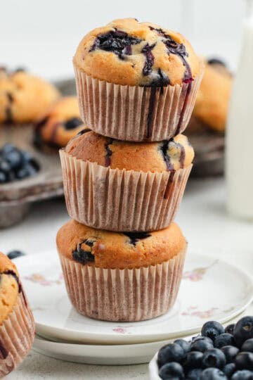 Three blueberry and cottage cheese muffins stacked on top of each other.
