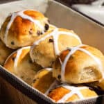 Hot cross buns inside of a bread basket for Easter Brunch.
