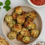 Air fryer chicken meatballs piled high inside of a round pasta bowl.
