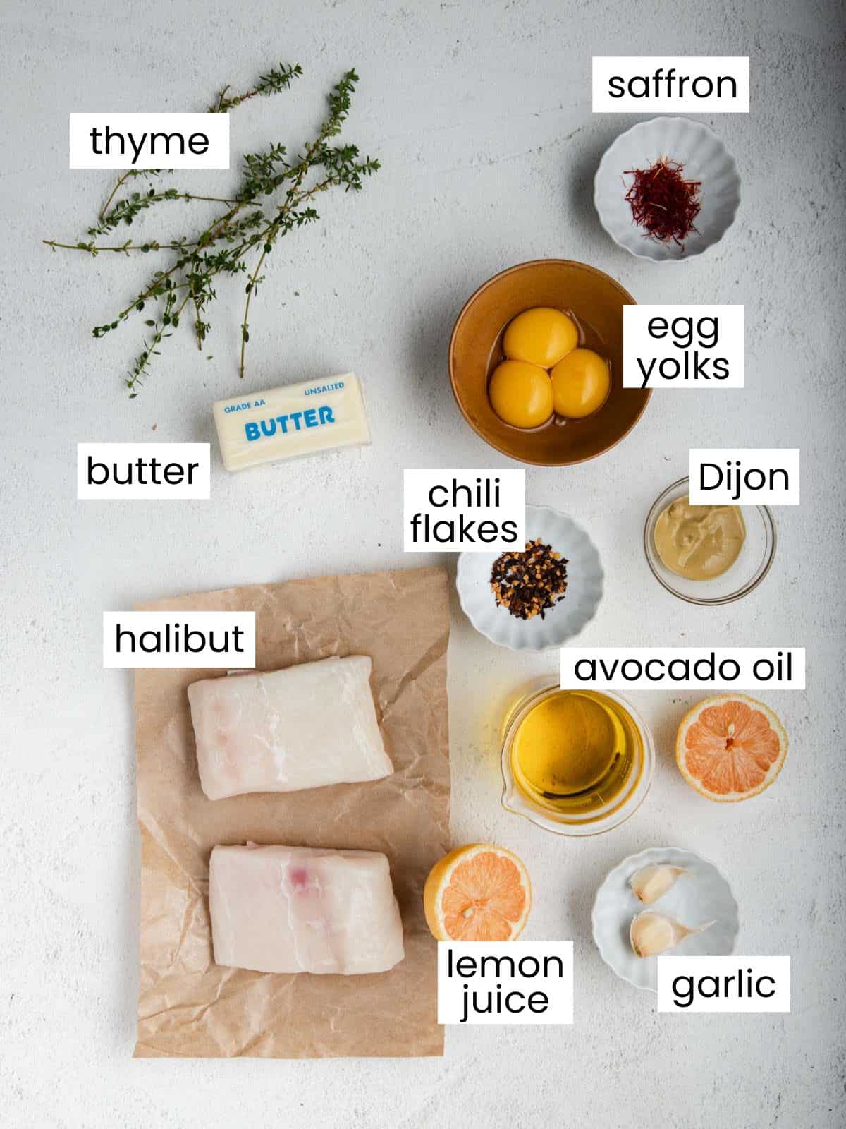 List of ingredients: Thyme, saffron, egg yolks, butter, Dijon, chili flakes, oil, lemon juice, garlic, and halibut.