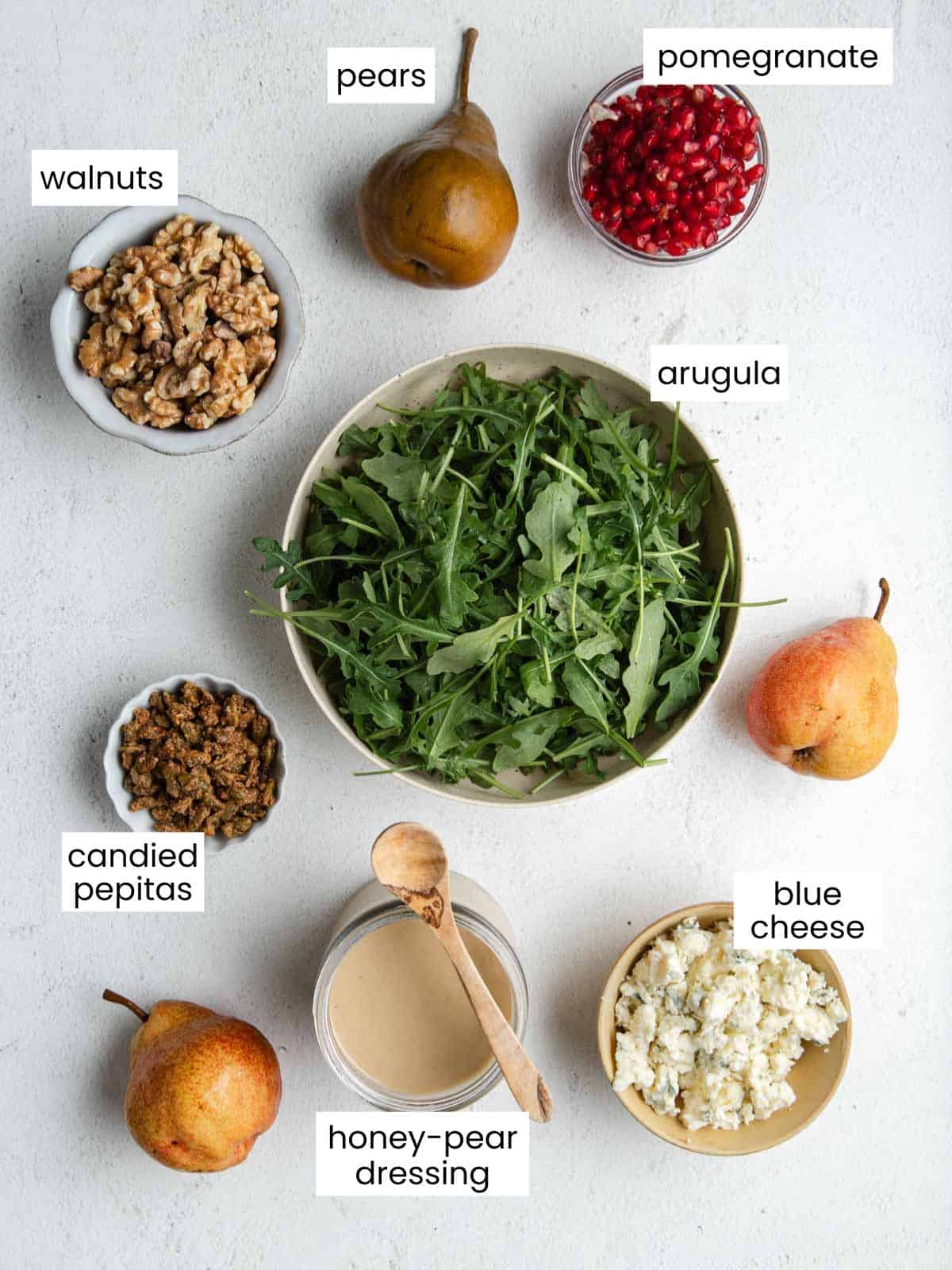 Pears, arugula, pomegranate seeds, candied pepitas, honey-pear dressing, walnuts, and blue cheese crumbles.
