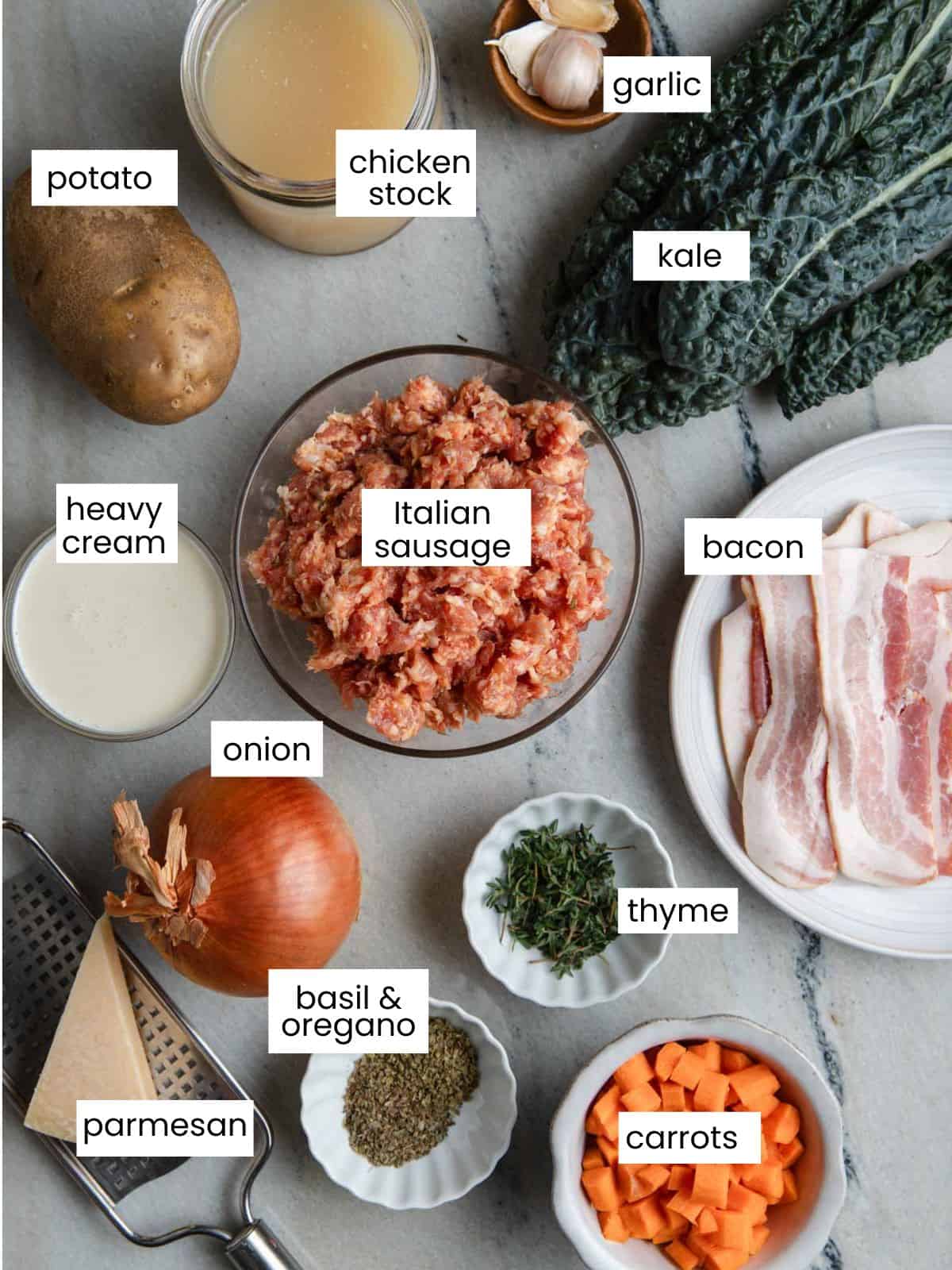 Garlic, chicken stock, potato, kale, heavy cream, Italian sausage, bacon, onion, thyme, dried herbs, carrots, and parmesan cheese.