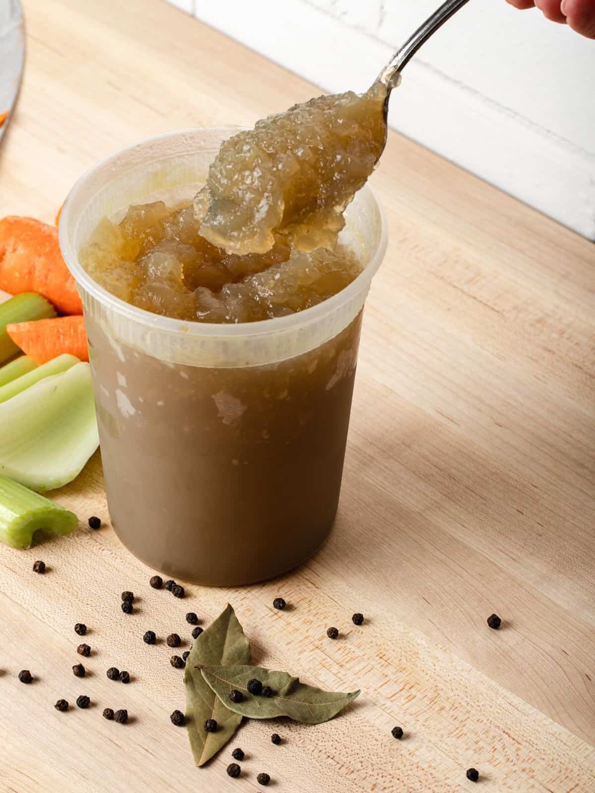 Gelatinous chicken stock on a spoon.
