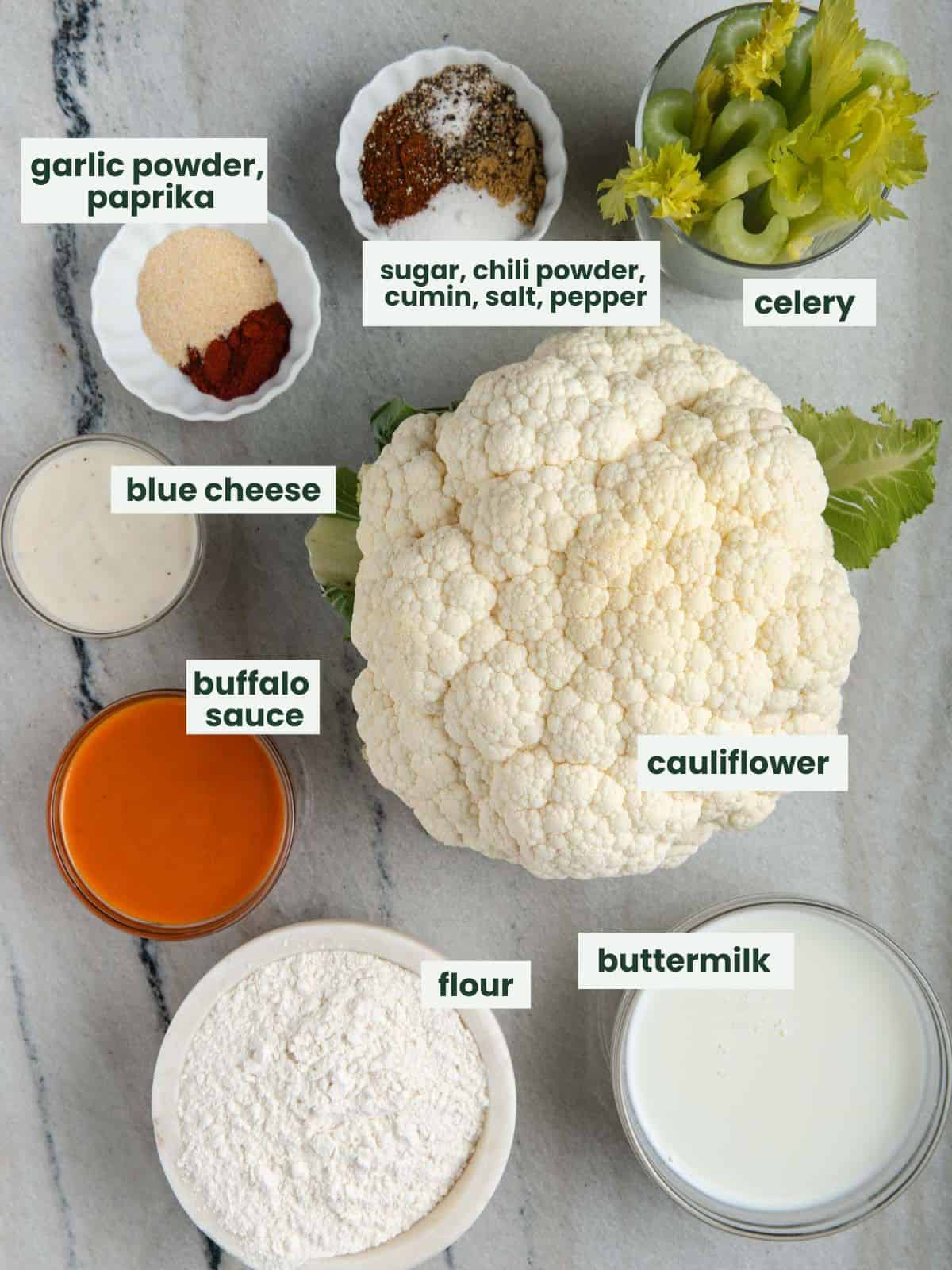 Cauliflower, celery, buttermilk, flour, buffalo sauce, blue cheese dressing, garlic powder, paprika, sugar, chili powder, cumin, salt, and pepper.