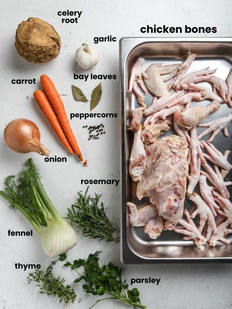 Chicken Bones, celery root, garlic, carrot, bay leaves, peppercorns, onion, fennel, thyme, rosemary, and parsley.